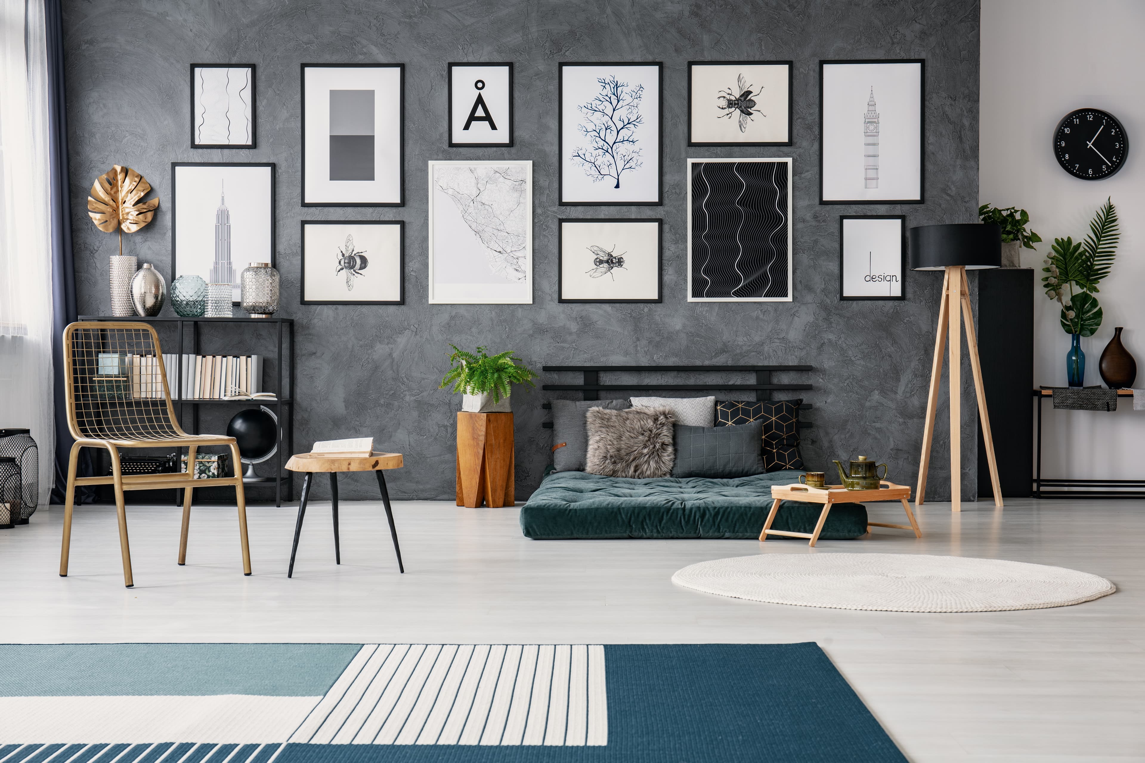 Gallery wall with framed artwork in a monochrome loft apartment